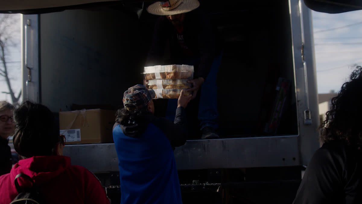 People unloading boxes from a truck