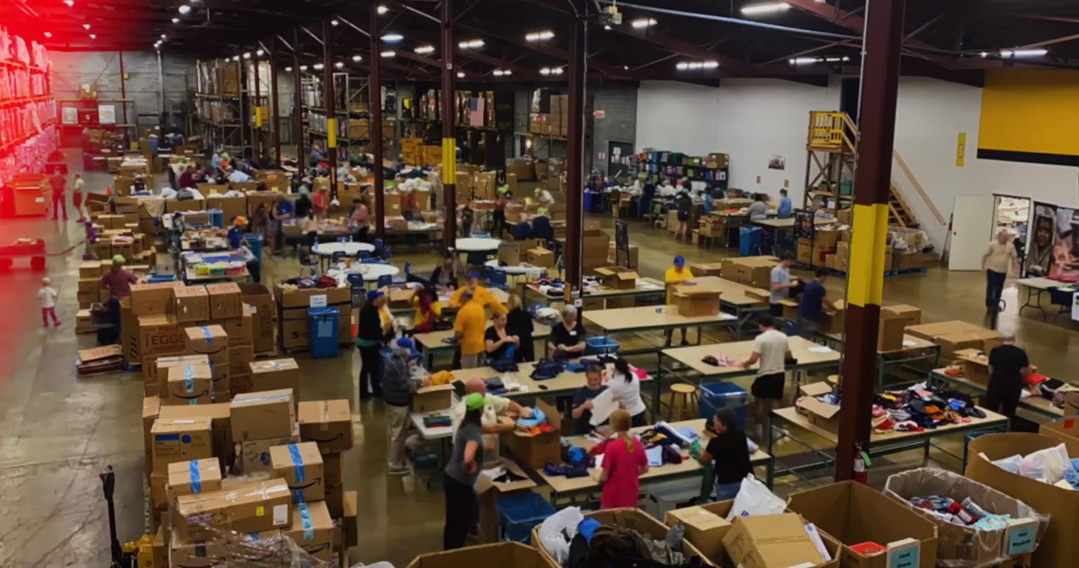 The warehouse floor full of volunteers