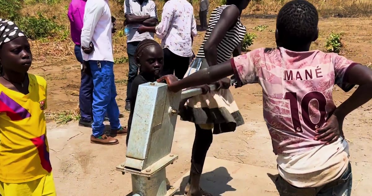 Children at the new well pump